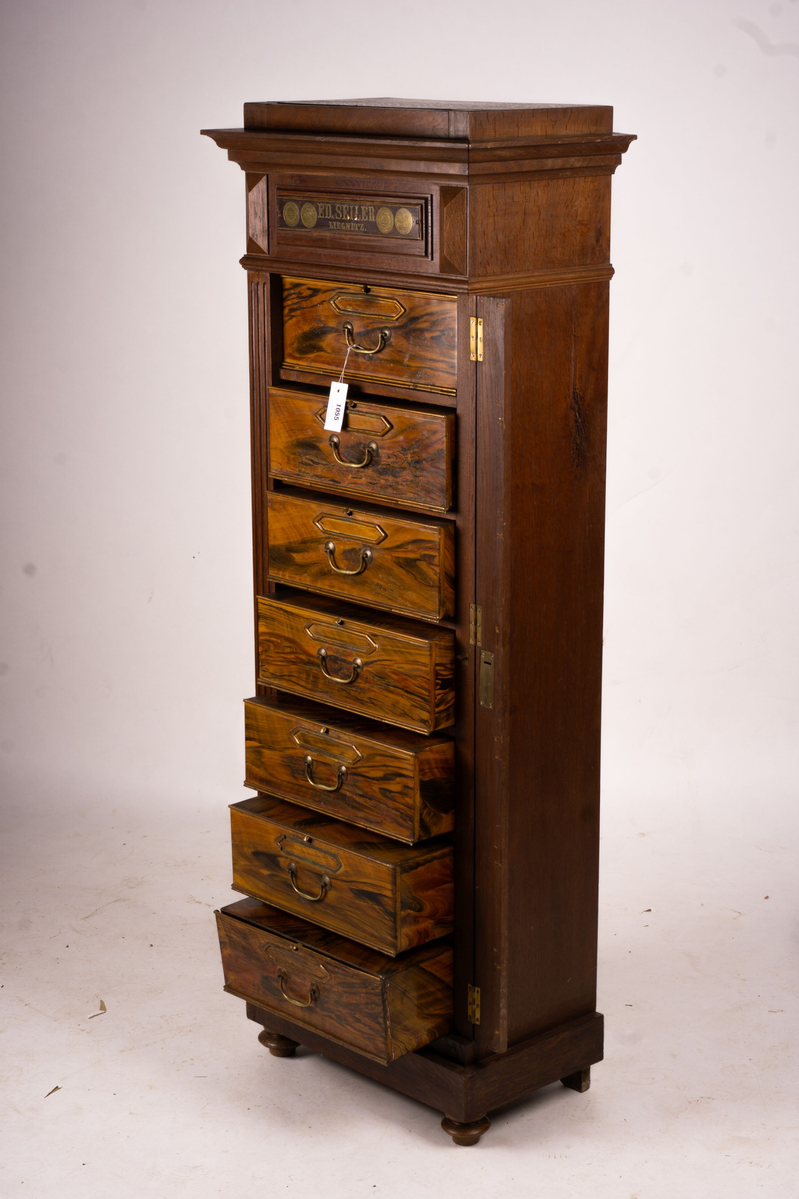 A late 19th / early 20th century oak and simulated walnut shop storage chest / filing cabinet, labelled Ed Seiler, width 57cm, depth 34cm, height 152cm